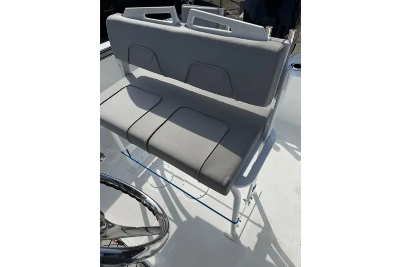 Slide: The Image of 2021 Wellcraft 202 Fisherman boat seat with gray upholstery and steering wheel. - 8