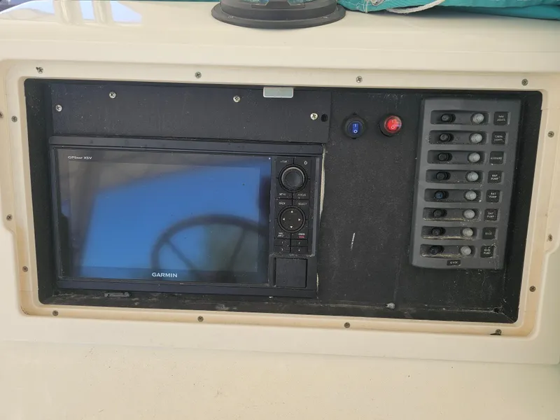 Slide: The Image of Garmin GPS system on 2000 Dorado 23 boat dashboard. - 16