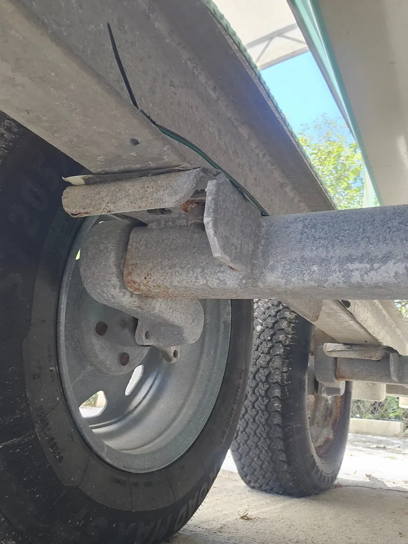 Slide: The Image of Close-up of a 2000 Dorado 23 boat trailer with damaged metal part. - 21