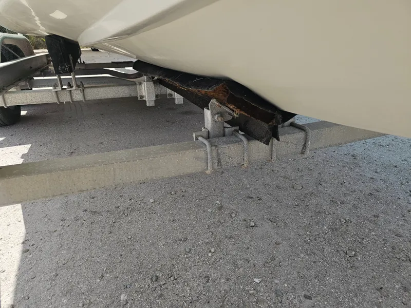 Slide: The Image of 2000 Dorado 23 boat on trailer with damaged support. - 33