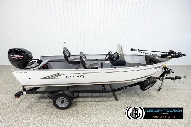 The Image of 2025 Lund 1600 Fury SS fishing boat on trailer, featuring Mercury outboard motor. - 1