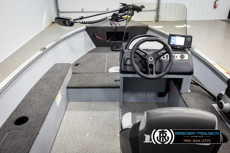 Slide: The Image of 2025 Lund 1600 Fury SS boat interior with steering wheel and navigation system. - 12