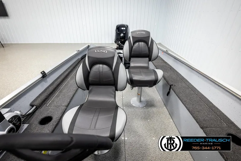 Slide: The Image of 2025 Lund 1600 Fury SS boat interior with two gray seats and steering console. - 15