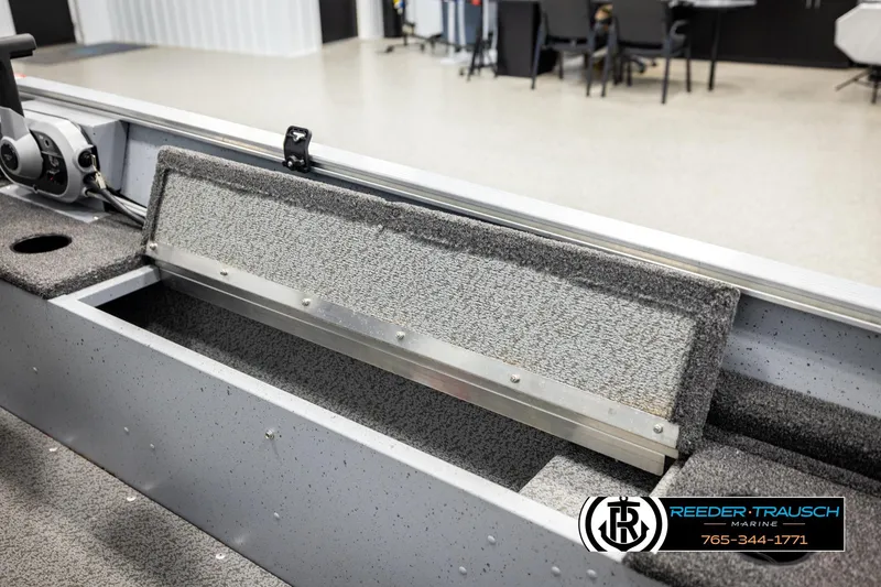 Slide: The Image of 2025 Lund 1600 Fury SS boat interior with open storage compartment and control panel. - 18