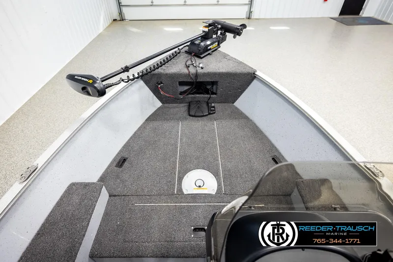 Slide: The Image of 2025 Lund 1600 Fury SS boat interior with trolling motor, showcased in a showroom. - 21