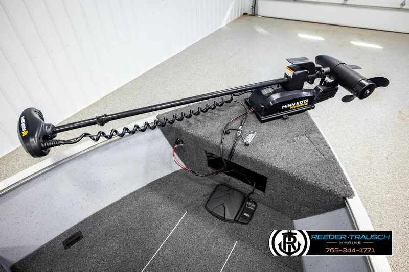 Slide: The Image of 2025 Lund 1600 Fury SS boat with Minn Kota trolling motor in a showroom. - 23