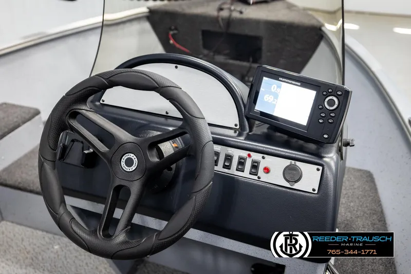 Slide: The Image of 2025 Lund 1600 Fury SS boat dashboard with steering wheel and Humminbird fish finder. - 28