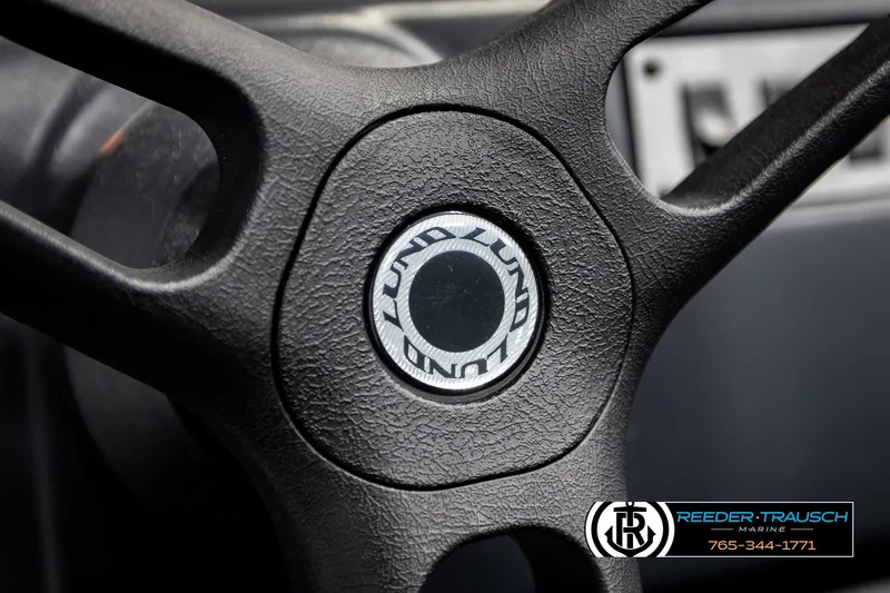 Slide: The Image of Steering wheel of 2025 Lund 1600 Fury SS boat, featuring textured grip. - 30