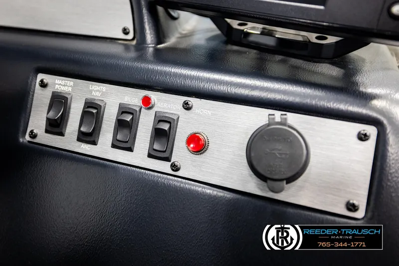 Slide: The Image of Control panel of 2025 Lund 1600 Fury SS boat with switches and power outlet. - 33