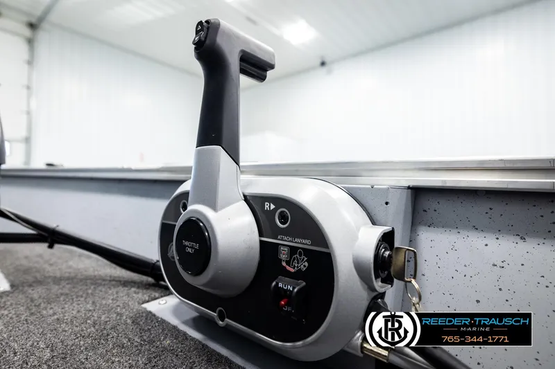 Slide: The Image of Close-up of 2025 Lund 1600 Fury SS boat throttle control in a showroom. - 34