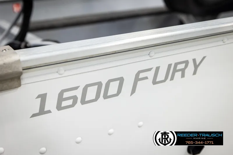 Slide: The Image of 2025 Lund 1600 Fury SS boat side view with branding and dealership logo. - 45