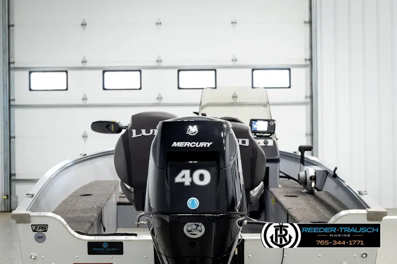 Slide: The Image of 2025 Lund 1600 Fury SS boat with Mercury 40 engine in a garage. - 5