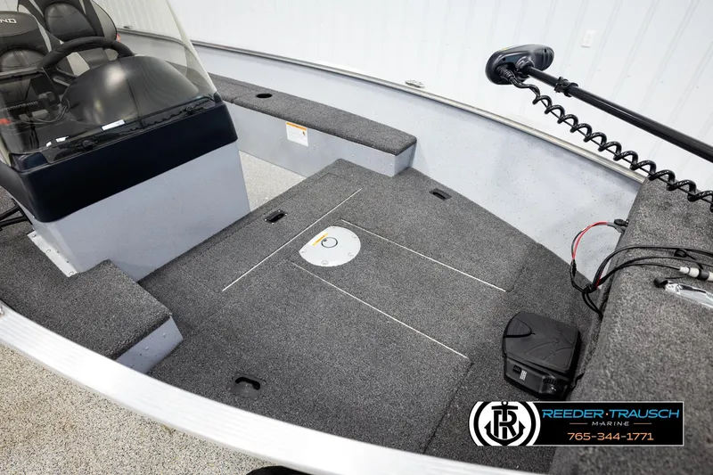 Slide: The Image of 2025 Lund 1600 Fury SS boat interior with carpeted deck and steering console. - 7