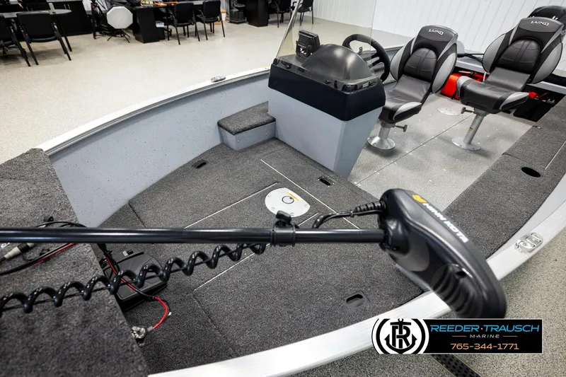 Slide: The Image of 2025 Lund 1600 Fury SS boat interior with steering console and seating. - 8