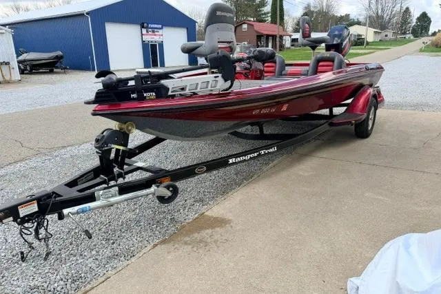 Slide: The Image of 1999 Ranger 461VS boat on trailer, parked outdoors near blue building. - 13