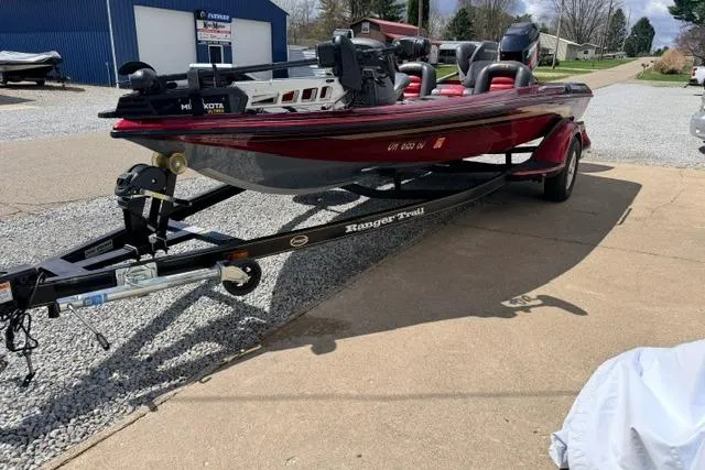 Slide: The Image of Red 1999 Ranger 461VS boat on trailer, parked on driveway near blue building. - 18