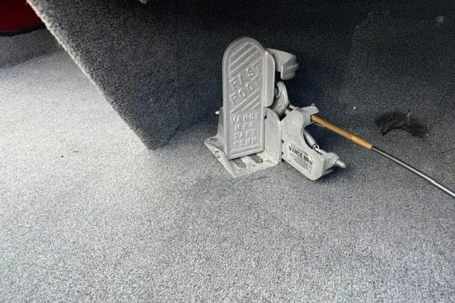 Slide: The Image of 1999 Ranger 461VS boat foot pedal on carpeted floor, featuring a trolling motor control. - 7