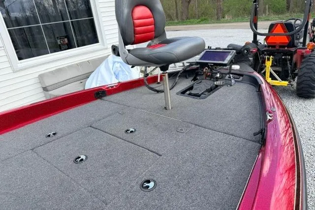 Slide: The Image of 1999 Ranger 461VS boat deck with seat and control panel, parked near a building. - 9