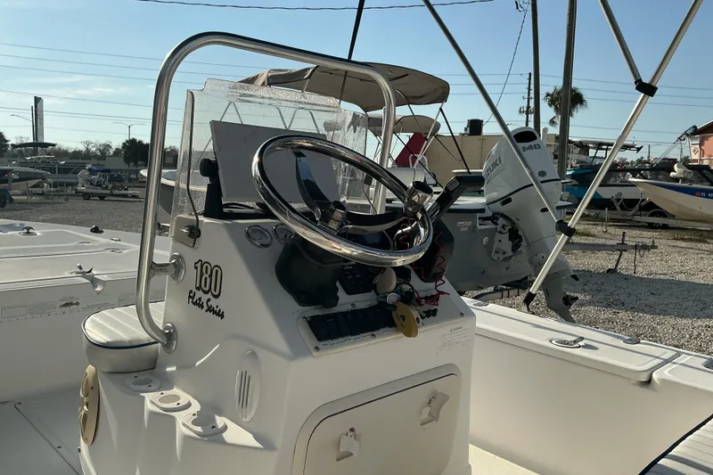 Slide: The Image of 2007 Sea Chaser 180 Flats boat interior with steering wheel and controls. - 10