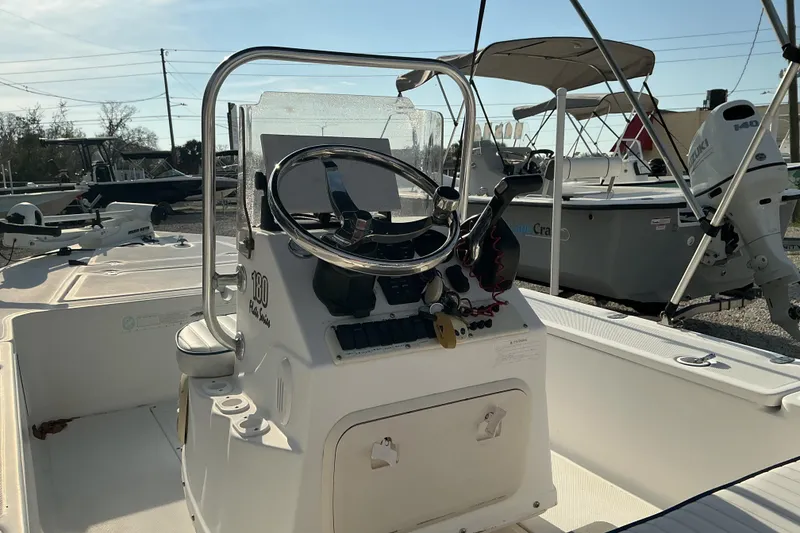 Slide: The Image of 2007 Sea Chaser 180 Flats boat interior with steering wheel and controls. - 6