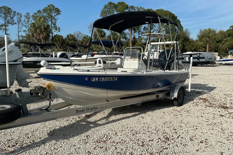 Slide: The Image of 2007 Sea Chaser 180 Flats boat on trailer, parked in a lot with other boats. - 7