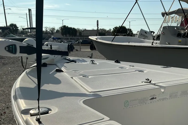 Slide: The Image of 2007 Sea Chaser 180 Flats boat with trolling motor, parked outdoors on a sunny day. - 8