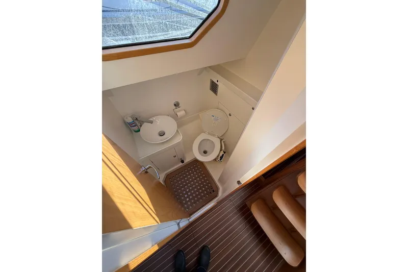 Slide: The Image of Compact bathroom in 2017 Boreal 47 yacht with sink, toilet, and wooden flooring. - 21