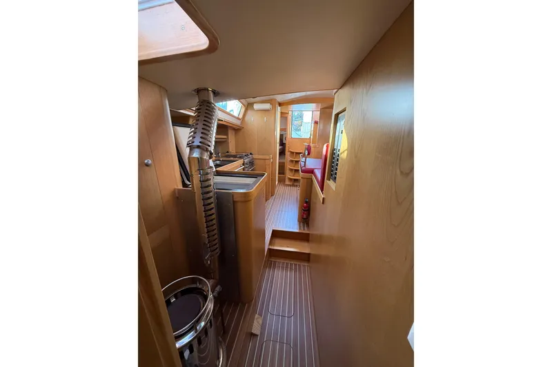 Slide: The Image of Interior of 2017 Boreal 47 yacht, featuring wood paneling and compact design. - 27