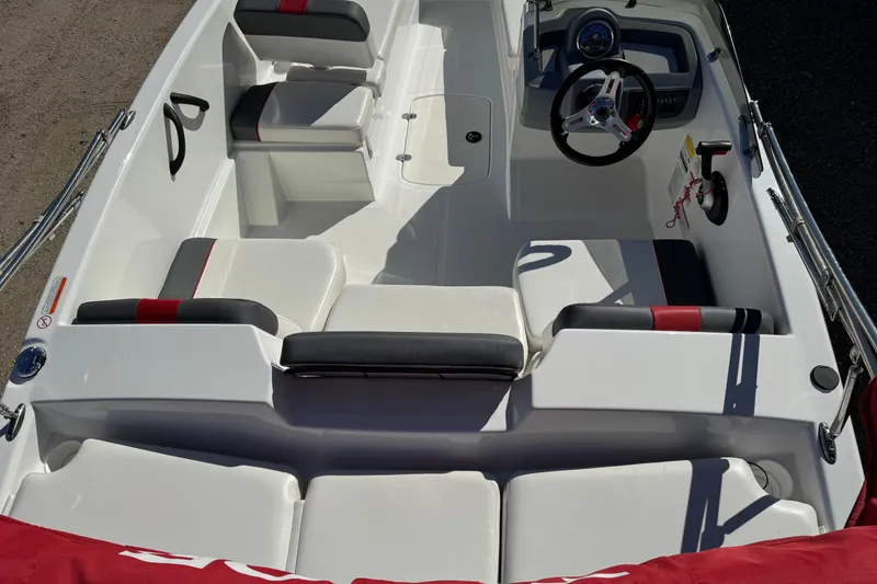 Slide: The Image of 2021 Tahoe T16 boat interior with seating and steering wheel, featuring red and black accents. - 5