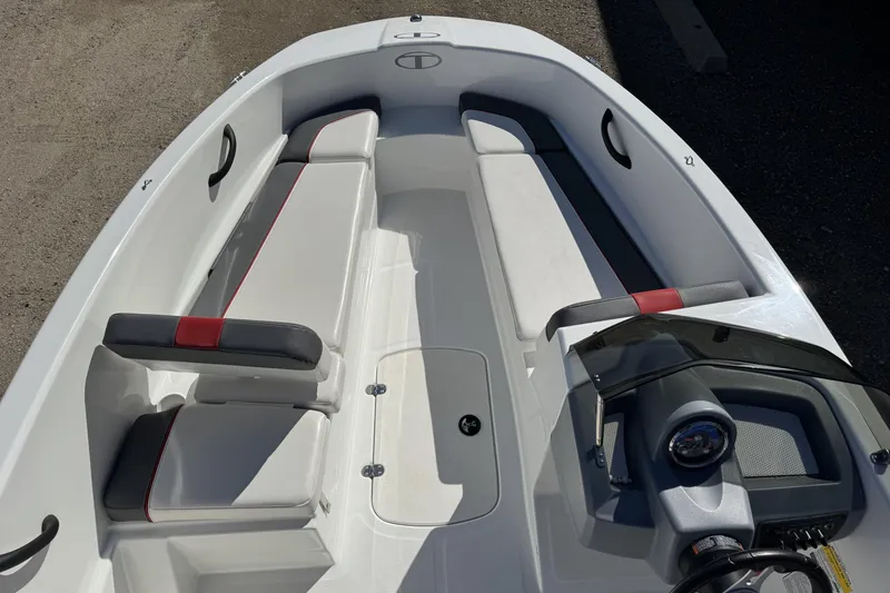 Slide: The Image of 2021 Tahoe T16 boat interior with white and gray seating, red accents, and steering console. - 6