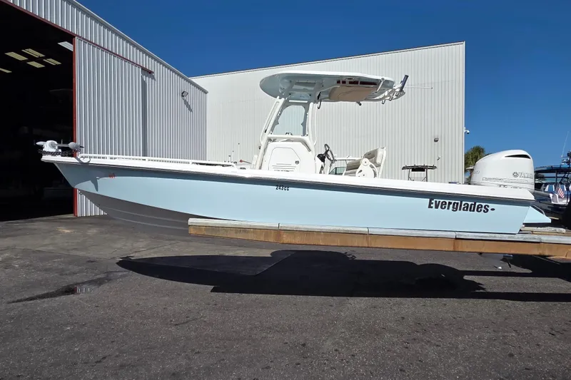 The Image of 2017 Everglades 243 Center Console boat on trailer outside a warehouse. - 0