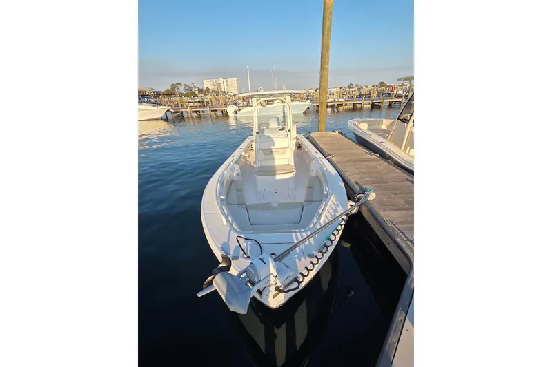 The Image of 2017 Everglades 243 Center Console boat docked at marina, calm water, clear sky. - 1