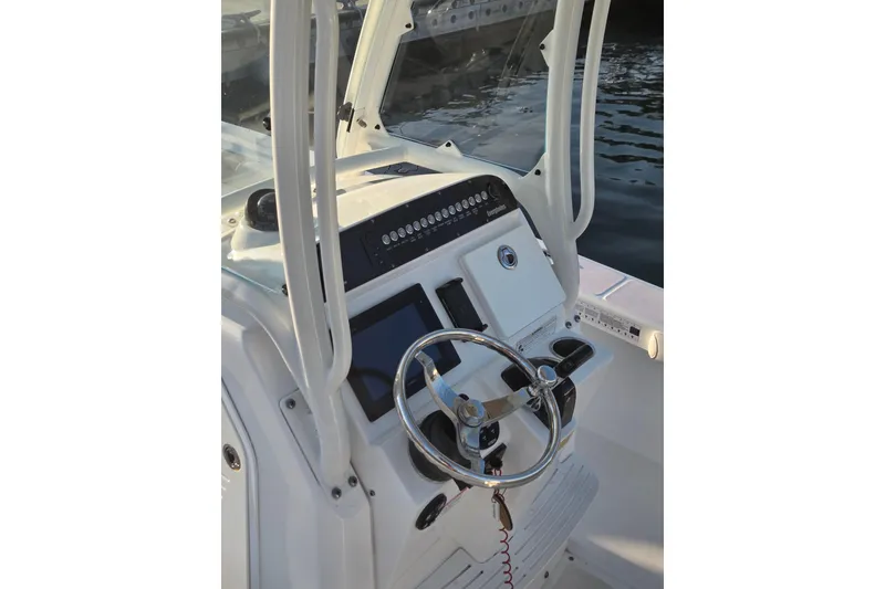 Slide: The Image of 2017 Everglades 243 Center Console boat dashboard with steering wheel and controls. - 6