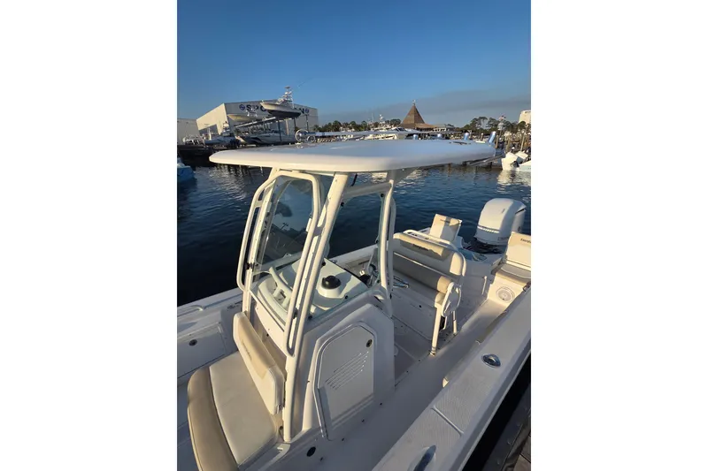 Slide: The Image of 2017 Everglades 243 Center Console boat docked at marina under clear blue sky. - 8