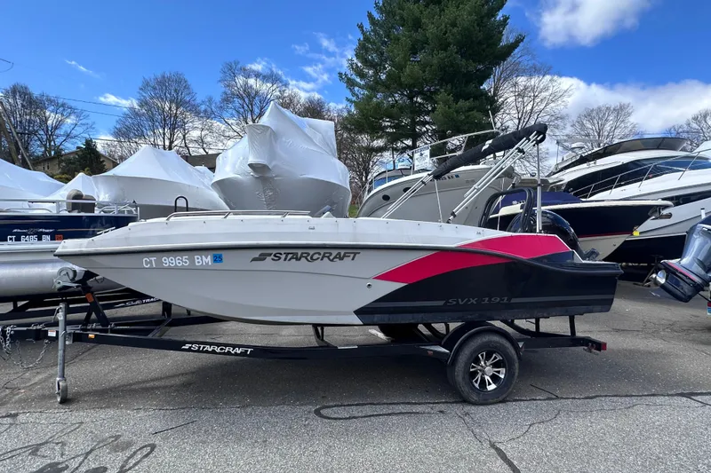 The Image of 2023 Starcraft SVX 191 OB boat on trailer, parked outdoors. - 0