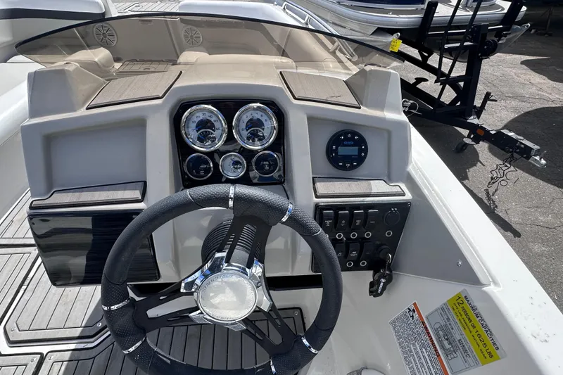 Slide: The Image of 2023 Starcraft SVX 191 OB boat dashboard with steering wheel and control panel. - 10