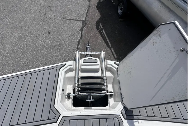 Slide: The Image of 2023 Starcraft SVX 191 OB boat bow with ladder and storage compartment. - 16