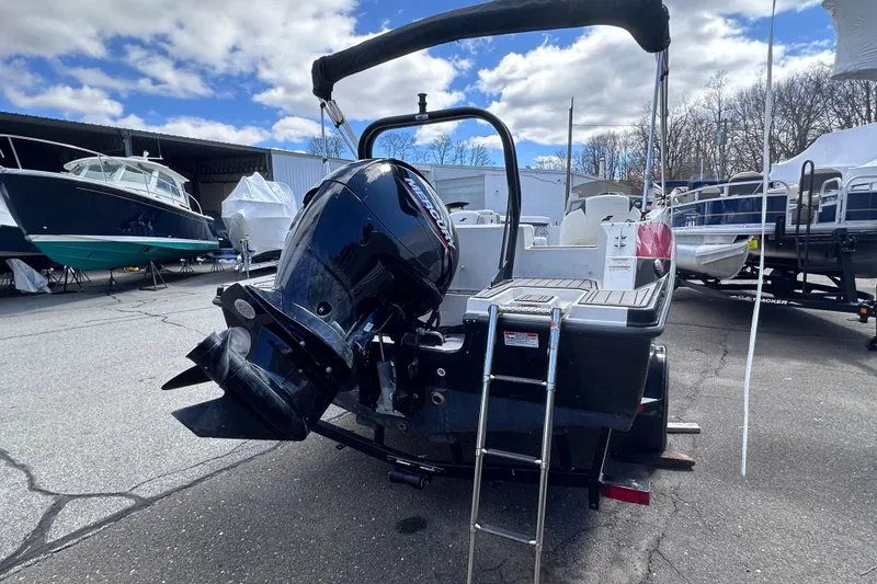 Slide: The Image of 2023 Starcraft SVX 191 OB boat with outboard motor and ladder, parked outdoors. - 4