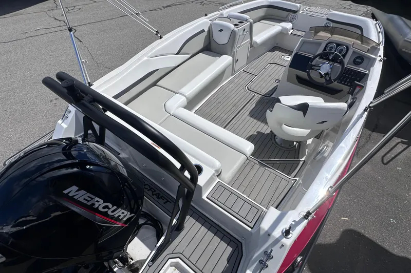 Slide: The Image of 2023 Starcraft SVX 191 OB boat interior with Mercury engine, featuring seating and steering console. - 5