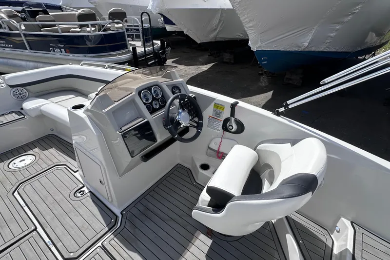 Slide: The Image of 2023 Starcraft SVX 191 OB boat interior with steering console and seating. - 9
