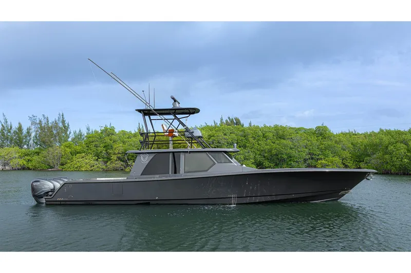 The Image of 2017 Gulf Crosser 52 boat on calm water with lush green background. - 1