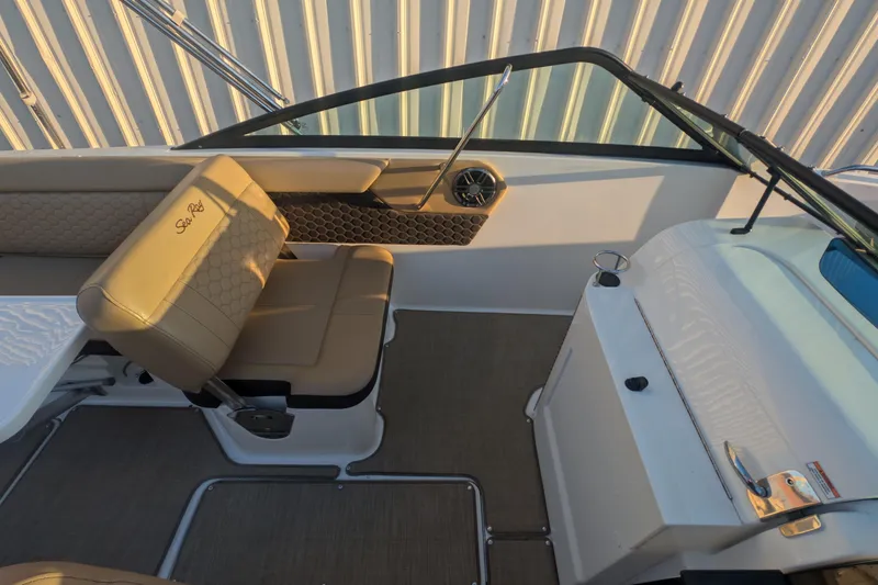 Slide: The Image of Interior of 2022 Sea Ray SDX 250 Outboard, featuring tan seating and sleek design. - 13