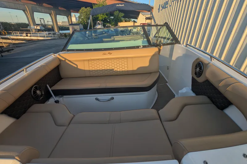 Slide: The Image of 2022 Sea Ray SDX 250 Outboard boat interior with tan seating and speakers. - 15