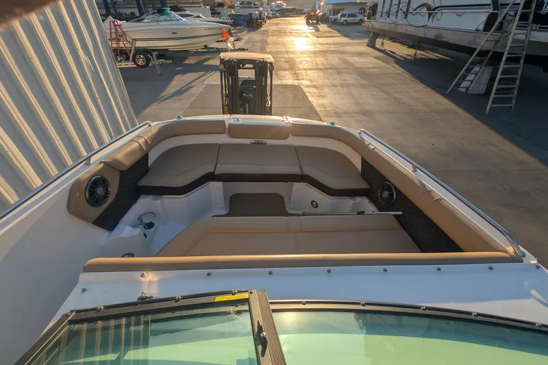 Slide: The Image of 2022 Sea Ray SDX 250 Outboard boat interior with tan seating at sunset. - 16