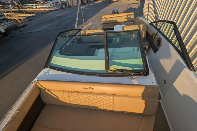 Slide: The Image of 2022 Sea Ray SDX 250 Outboard boat interior with tan seating and windshield. - 17