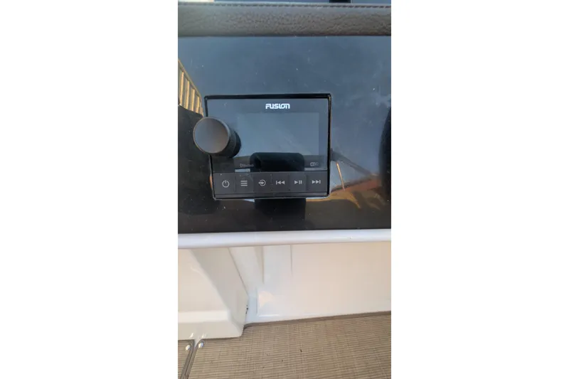 Slide: The Image of Fusion audio system on 2022 Sea Ray SDX 250 Outboard boat dashboard. - 20