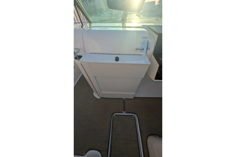 Slide: The Image of 2022 Sea Ray SDX 250 Outboard interior with sunlit helm and sleek design. - 21