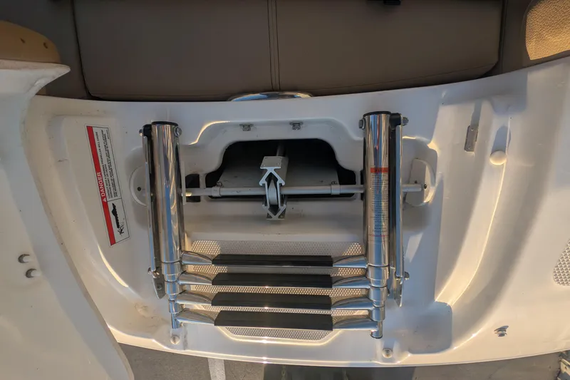 Slide: The Image of 2022 Sea Ray SDX 250 Outboard swim platform with retractable ladder and safety warning. - 28