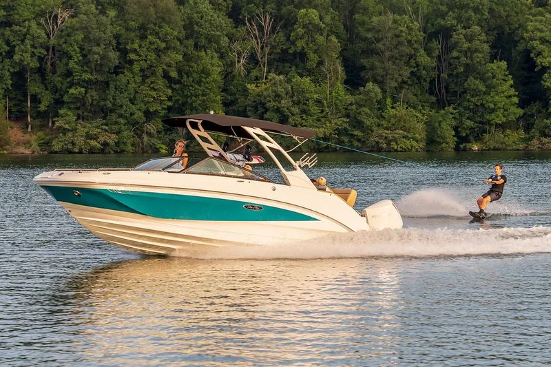 Slide: The Image of Manufacturer Provided Image: 2022 Sea Ray SDX 250 Outboard boat towing a wakeboarder on a scenic lake. - 34