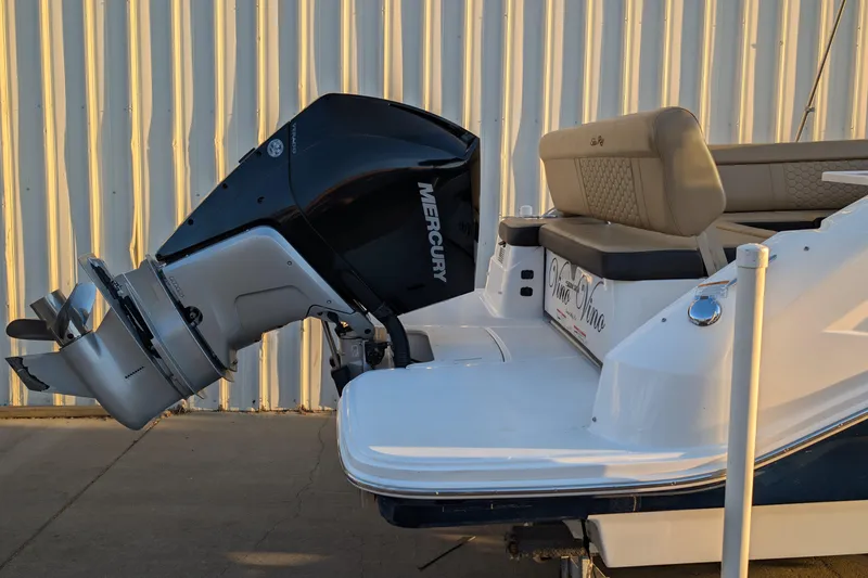 Slide: The Image of 2022 Sea Ray SDX 250 Outboard boat with Mercury engine, docked near a corrugated wall. - 5